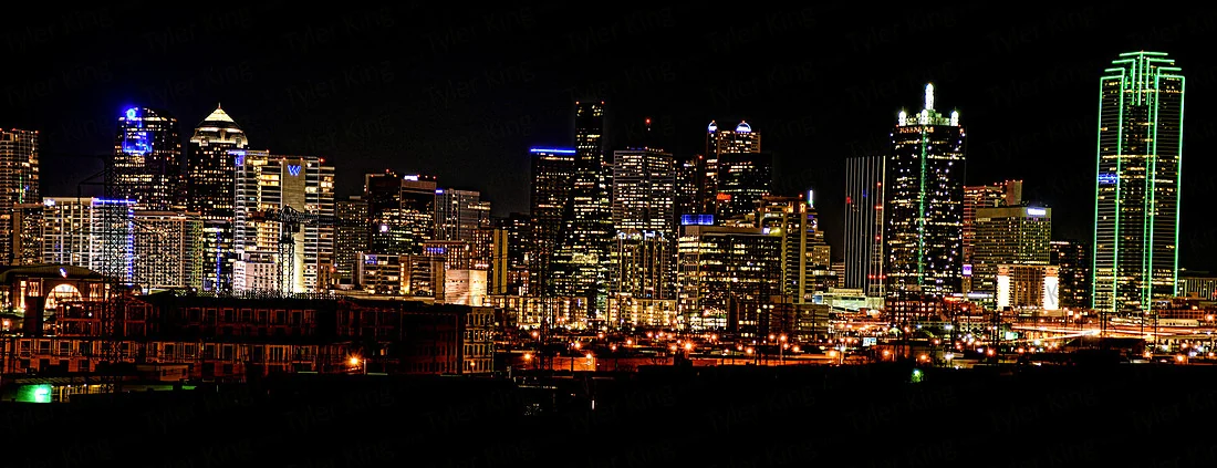 An illuminated panorama of the Dallas skyline at night